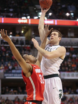 Michigan State's Matt Costello scores against Ohio State's Trevor Thompson during the first half Friday in Indianapolis.