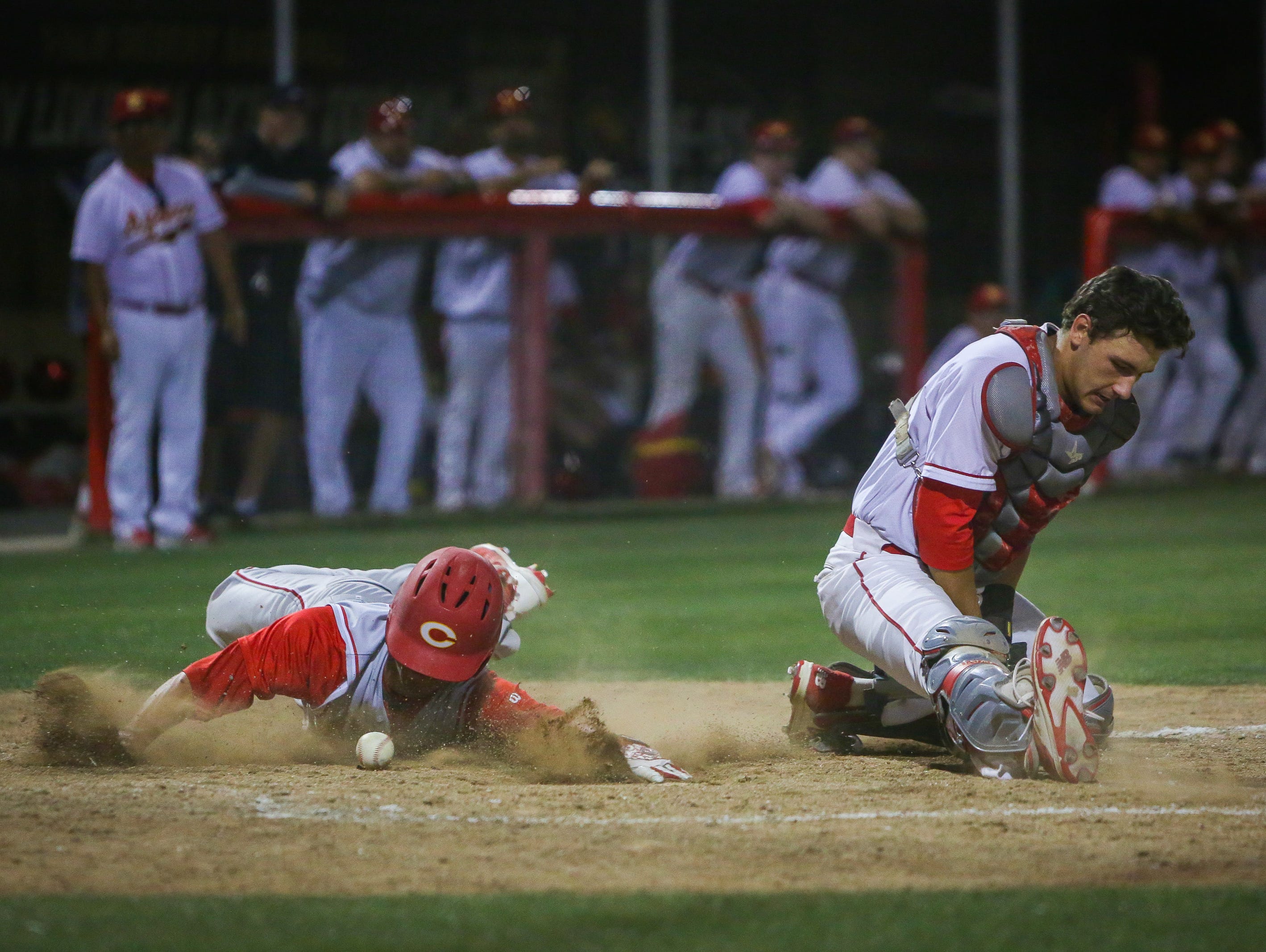 Corona's Chase Robison slides and scores.