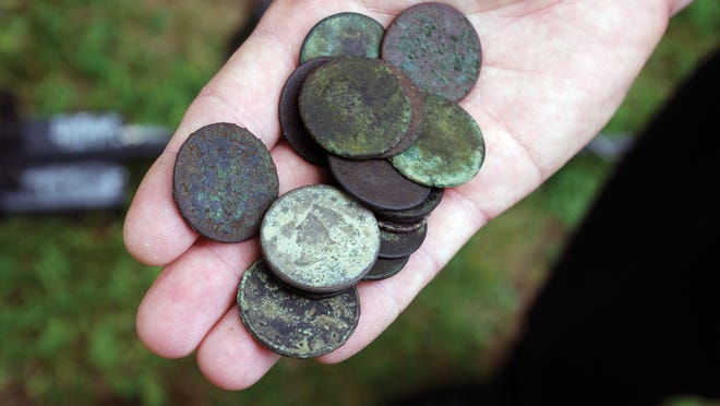 A closeup shot of coins found by a metal detector.