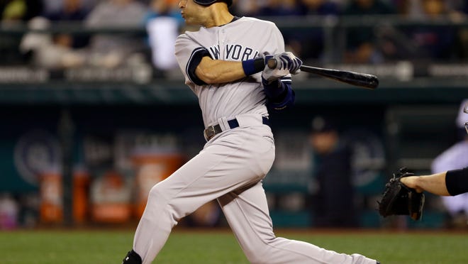 
The Yankees’ Derek Jeter follows through on a two-run single against the Mariners on Thursday night. 
