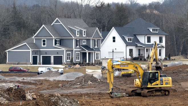 Workers move dirt for new homes in Enderly Pointe at Ladd Park in Franklin, Tenn.  on Wednesday, Feb. 7, 2018. 