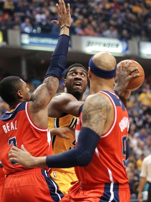Indiana Pacers center Roy Hibbert looks to take a shot over Washington Wizards guard Bradley Beal  and forward Drew Gooden  in the first half of the game at Bankers Life Fieldhouse on Tuesday, April 14, 2015.