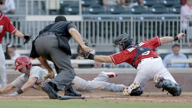 El Paso catcher Austin Hedges follows through after tagging Memphis base runner Harrison Bader at home plate Thursday. Bader was called safe. 