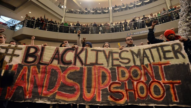 Demonstrators filled the Mall of America rotunda and chanted "Black lives matter" to protest police brutality, Saturday, Dec. 12, 2014, in Bloomington, Minn.  The group Black Lives Matter Minneapolis had more than 3,000 people confirm on Facebook that they would attend. Attendance figures weren't immediately available.