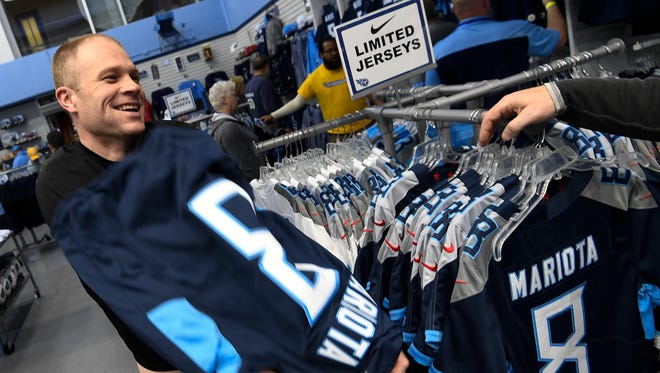 Titans fan Dane Baron tries on a Marcus Mariota jersey during the draft party in April at Nissan Stadium.