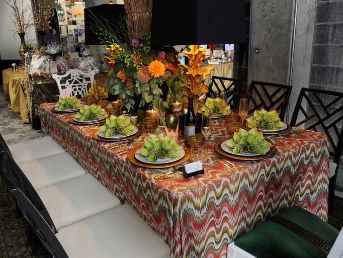 Designer Corey Damen Jenkins of Design With Vision Elegant Interiors says his concept was "Rooftop Paradise." He chose a chevron textile with autumnal color palette for the fitted table skirt. He mixed Chippendale chairswith Fretwork-styled side seating. In the center was an eight-foot tall floral tree arrangement by Affordable Flowers.