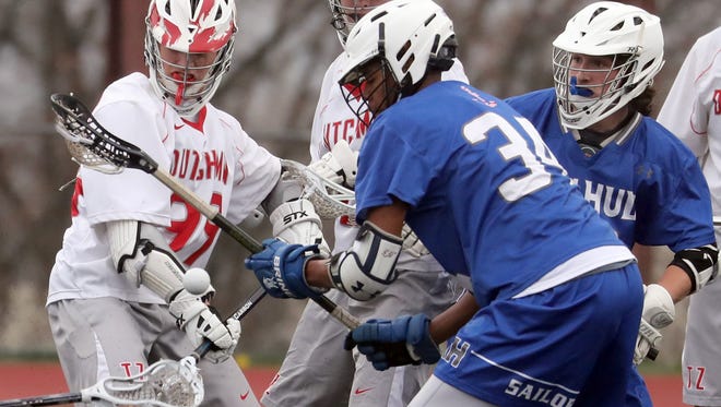 John Lynch of Tappan Zee and Menki Gray of Hendrick Hudson battle for a loose ball during a varsity lacrosse game at Tappan Zee High School April 24, 2018. Hendrick Hudson defeated Tappan Zee 9-4.