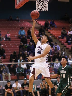 Shiprock's Antonio Cota beats the Thoreau defense for a layup in the first half on Saturday at the Chieftain Pit.