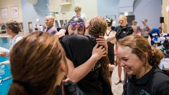 Fossil Ridge High School swimmer Caraline Baker embraces a teammate during the Colorado High School Activities Association Girls Class 5A State Championships held Feb. 10, 2017, at the Veterans Memorial Aquatics Center in Thornton. Baker plans to swim for the University of Southern California.
