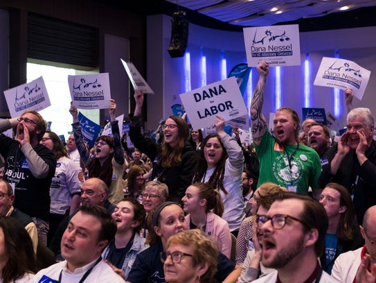 Supporters hold signs and cheer during the 2018 State