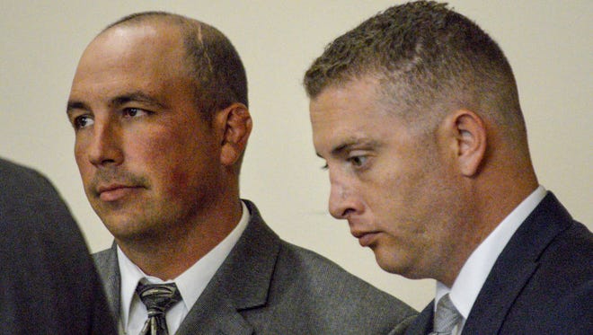 In this Aug. 18, 2015, photo, former Albuquerque Detective Keith Sandy, left, and Officer Dominique Perez speak with attorneys during a preliminary hearing in Albuquerque, N.M. The case against two former New Mexico police officers charged in the death of a homeless man ended in a mistrial Tuesday, Oct. 11, 2016, when jurors told the judge they were hopelessly deadlocked on the counts of second-degree murder.