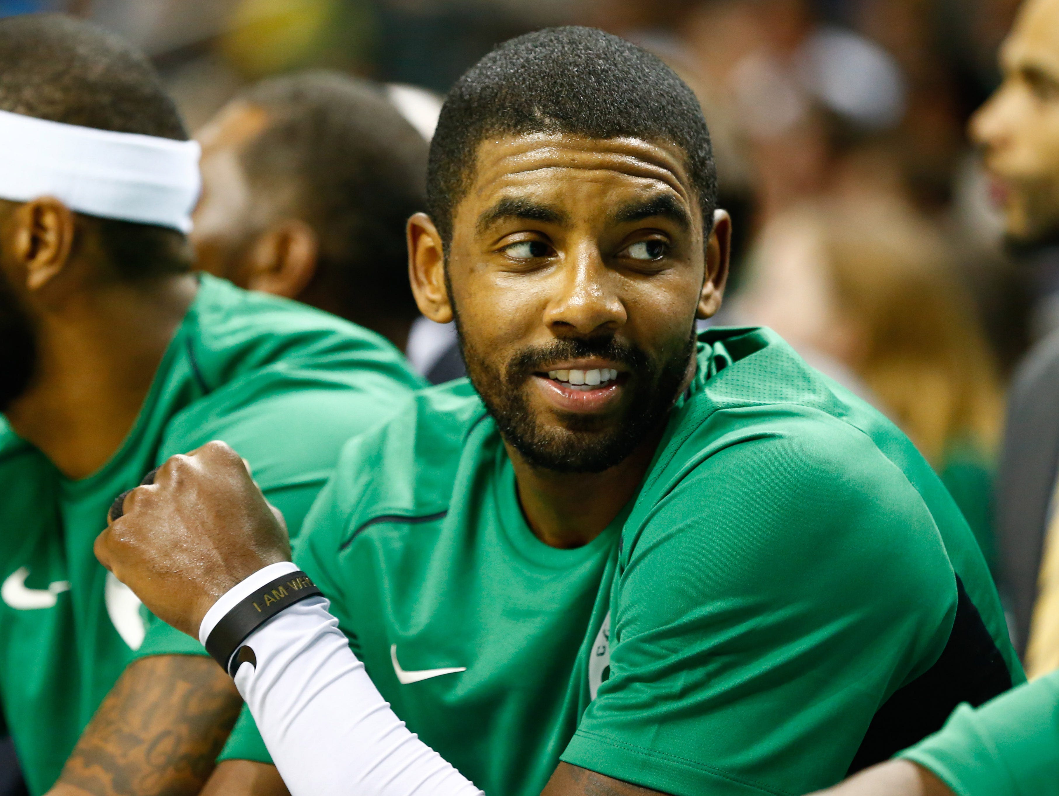 Boston Celtics guard Kyrie Irving (11) sits on the bench in the second half against the Charlotte Hornets at Spectrum Center.