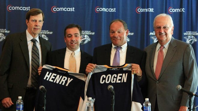 Nashville Predators General Manager David Poile, left, and Chairman Tom Cigarran, right, with Sean Henry, second from left, and Jeff Cogen, during a press conference in 2010.