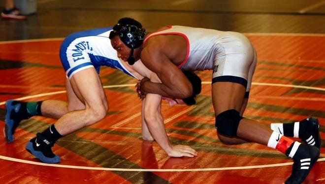 Bound Brook’s Mekhi Lewis (right) and Holmdel’s Chris Anmirad wrestle in a Region V bout on Friday at Hunterdon Central.