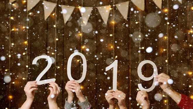 people hands showing 2019 numbers on wooden background - new year holiday concept