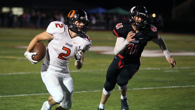 Sprague's Carter James runs the ball as the Olys defeat the McMinnville Grizzlies 49-27 in Greater Valley Conference game on Friday, Sept. 23, 2016, in McMinnville.