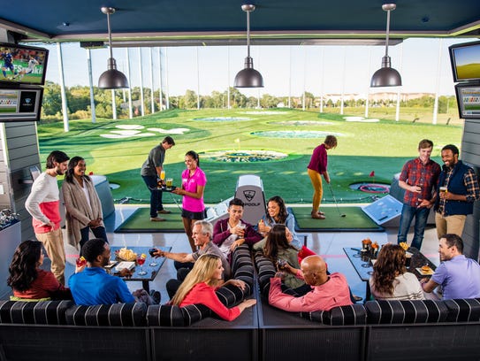Guests playing golf at a Topgolf in Naperville, Ill.