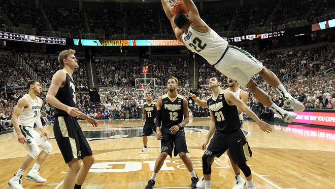 Michigan State Spartans guard Miles Bridges (22) dunks the ball over Purdue Boilermakers forward Matt Haarms (32) and Purdue Boilermakers forward Vincent Edwards (12) and Purdue Boilermakers guard Dakota Mathias (31) during the first half of a game at the Jack Breslin Student Events Center. Mandatory Credit: Mike Carter-USA TODAY Sports