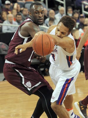 KEVIN SWANK / Special to the Courier & PressUE's Jaylon Brown, 3, (right) gets tripped up by Southern Illinois' Aaron Cook, 10, during the first half of their game. The University of Evansville men's basketball team lost to Southern Illinois University 61-73 on Saturday afternoon, January 14, 2017 during their game at the Ford Center in Evansville, Ind.