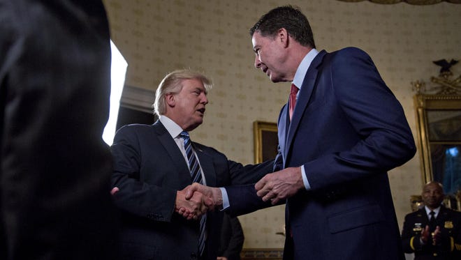 President Trump shakes hands with FBI Director James Comey during an Inaugural Law Enforcement Officers and First Responders Reception at the White House on Jan. 22, 2017.