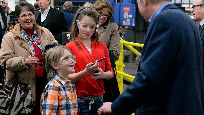 Reid Rusthoven, 8, and his sister Elsa, 11, talk with Michigan Gov. Rick Snyder after he spoke at Franchino Mold and Engineering, Wednesday in Lansing.