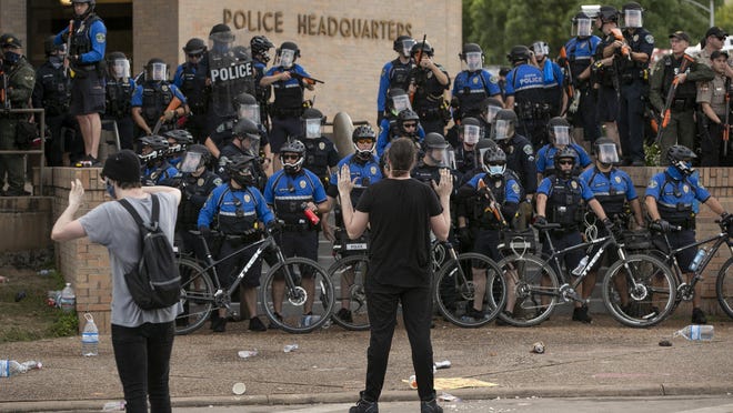 Austin police officers use bicycles to block the entrance to the Austin Police Department headquarters during protests on May 30.