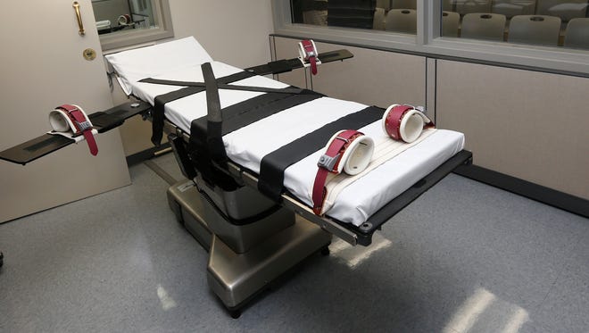 FILE - This Oct. 9, 2014 file photo shows the gurney in the the execution chamber at the Oklahoma State Penitentiary in McAlester, Okla. Exactly one year after a botched lethal injection, attorneys for other Oklahoma death row inmates were set to ask the U.S. Supreme Court Wednesday, April 29, 2015 to outlaw a sedative used in the procedure — a ruling that could force several states to either find new execution drugs or change the way they put prisoners to death.. (AP Photo/Sue Ogrocki, File)