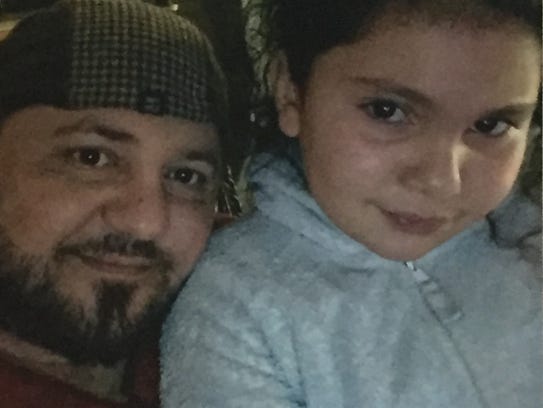 Family photo of Haydar Butris with one of his daughters.