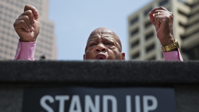 Rep. John Lewis, D-Ga., addresses protesters near a National Rifle Association convention in Atlanta on April 29, 2017. President Donald Trump's speech at the convention sparked protests from people advocating for stricter gun control measures. Trump has disparaged Lewis' congressional district and Atlanta, saying it is "falling apart" and "crime infested." The president will attend the college football championship game at the city's new stadium on Monday, Jan. 8.