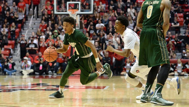 CSU's Prentiss Nixon drives past San Diego State's Jeremy Hemsley during Tuesday night's game in San Diego. Nixon, a freshman, scored 15 points while making his first start at point guard.