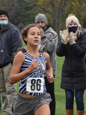 Sophia Santiago of Mercer County surges to the finish line of the IHSA Class 1A cross country regional on Saturday, Oct. 24, at Saukie Golf Course in Rock Island. Her time was 20:48 for 19th place.