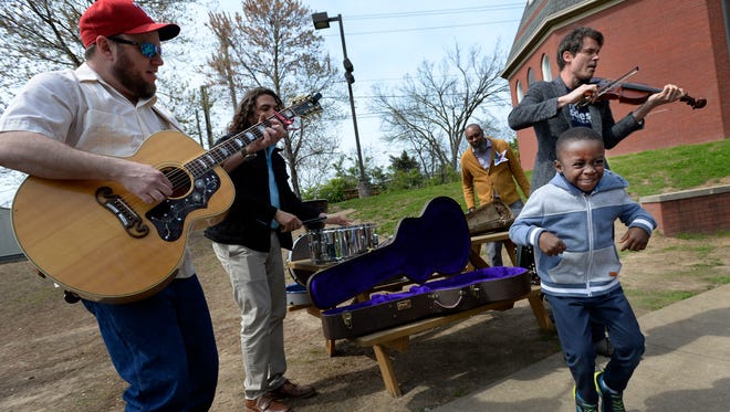 Clayton Fawknotson, 5, dances as Old Crow Medicine Show members Critter Fuqua, left, and Ketch Secor, right, volunteer their time to play for students at Episcopal School of Nashville,  Wednesday, April 11, 2018. Secor, Fuqua, and their band Old Crow Medicine Show are releasing a new album called "Volunteer" on April 20.