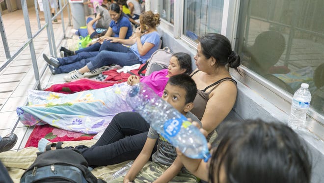 Migrants from Central America wait in line to ask for asylum outside U.S. Port of Entry in Nogales.