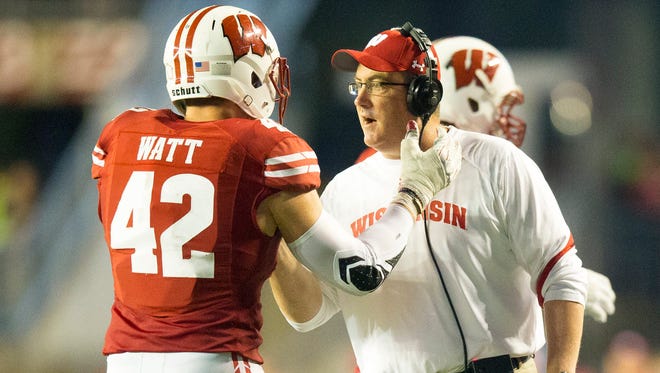 Badgers head coach Paul Chryst greets linebacker T.J. Watt during the loss to Ohio State on Saturday.