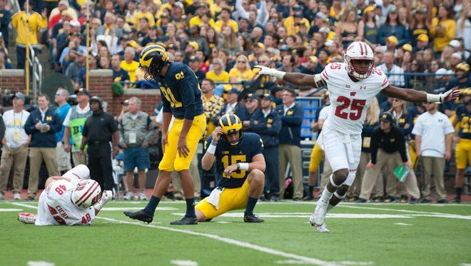 Michigan kicker Kenny Allen  and holder Garrett Moores react after Allen missed the first of two second-quarter field-goal attempts. Also reacting is Wisconsin cornerback Derrick Tindal (25).