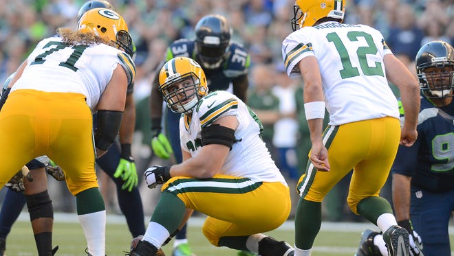 Green Bay Packers center Corey Linsley (63) looks back at quarterback Aaron Rodgers (12) for signals during the game against the Seattle Seahawks at CenturyLink Field in Seattle on Sept. 4, 2014.