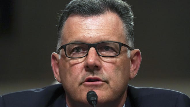 In this Tuesday, June 5, 2018, file photo, former USA Gymnastics president Steve Penny invokes his right under the Fifth Amendment not to answer questions during a Senate Subcommittee on Consumer Protection, Product Safety, Insurance, and Data Security, on Capitol Hill in Washington. In a statement late Wednesday, Oct. 17, 2018, the Walker County district attorney's office in Huntsville, Texas, said that Penny has been arrested after a Texas grand jury indicted him, alleging he tampered with evidence in the sexual assault investigation of now-imprisoned gymnastics doctor Larry Nassar. Penny now awaits extradition to Texas.