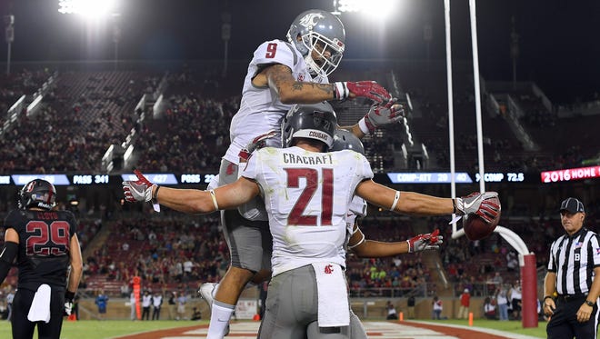 River Cracraft #21, Robert Lewis #15 and Gabe Marks #9 of the Washington State Cougars celebrates after Cracraft caught a touchdown pass against the Stanford Cardinal during the second half of their NCAA football game at Stanford Stadium on October 8, 2016 in Palo Alto, California.