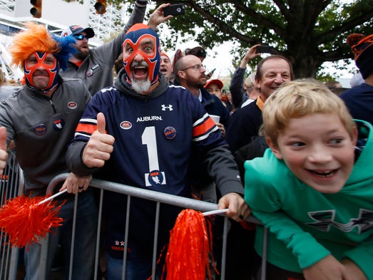 Auburn Tigers fans wait on the team to go through Tiger