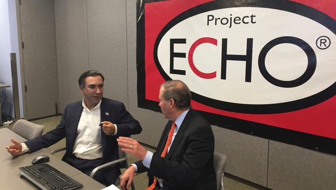 In this Dec. 14, 2016 photo, Project ECHO Director Sanjeev Arora (left) talks with Sen. Tom Udall, D-N.M., about a model for mentoring physicians in isolated rural areas that could be expanded under legislation signed in December by President Barack Obama.