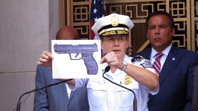 FILE - In this Thursday, Sept. 15, 2016, file photo, Columbus, Ohio, Police Chief Kim Jacobs displays a photo of the type of BB gun police say Tyre King pulled from his waistband before he was shot and killed by a police officer.