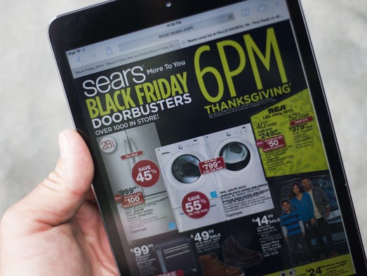 A "Black Friday" advertisement for Sears is seen on
