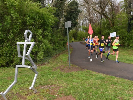 Marathoners run along the Third Creek Greenway on mile