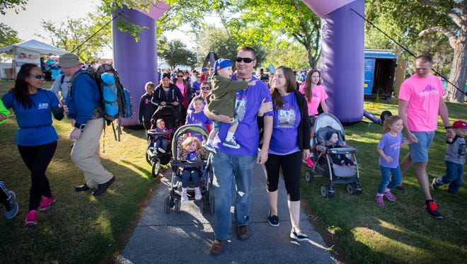 Glen and Jessica Adkins walk with their son Walter and other members of “Team Wallaby” at the start of the March of Dimes annual March for Babies fundraiser at Albert Johnson Park, April 30, 2016. Walter was born prematurely at just 14 ½ inches and 2 ½ pounds after his mother Jessica was diagnosed with preeclampsia.