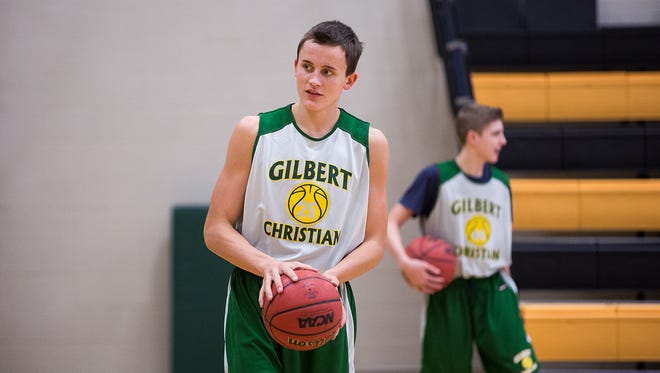 Mitchell Lightfoot, a senior at Gilbert Christian High School, practices in the school gym with the basketball team on Dec. 3, 2014, in Gilbert.