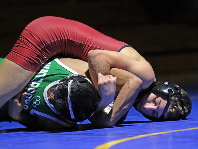Wauwatosa wrestler Dayton Lewis works to pin Waterford