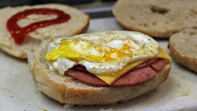 A pork roll, egg, and cheese sandwich is prepped at Alfa Bagels on Route 10 in Randolph.