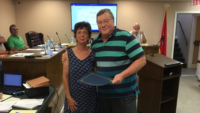Ashland City Mayor Rick Johnson presents the proclamation to Chris LaCrosse's wife Rebecca.