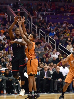 Apr 2, 2017; Phoenix, AZ, USA; Houston Rockets forward Troy Williams (14) passes the ball by Phoenix Suns guard Tyler Ulis (8) during the second half at Talking Stick Resort Arena. The Rockets won 123-116.