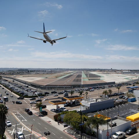 A plane lands at San Diego International Airport o